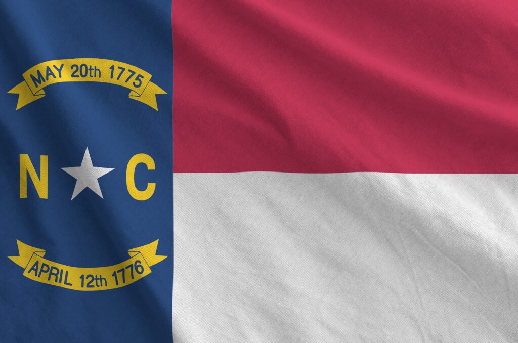 North Carolina US state flag depicted on folded wavy fabric of old cloth North Carolina Jewish Community Life
